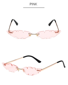 Close-up of pink leaf-shaped rimless sunglasses with gold temples and jagged edges