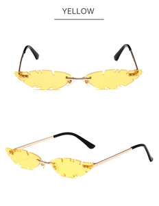 Detailed macro view of yellow maple leaf shaped rimless sunglasses with gold metal temples