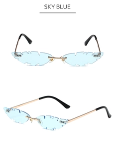 Macro view of blue feather-shaped rimless sunglasses with gold metal temples