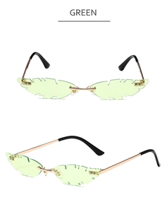 Detail view of leaf-shaped rimless sunglasses with green lenses and gold metal temples