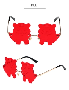Detailed view of red tiger-shaped lenses and golden metal frames for party sunglasses