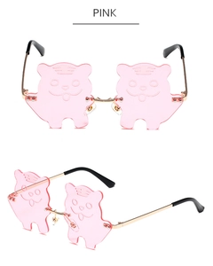 Detailed view of pink tiger-shaped lenses and gold metal frame on fashion sunglasses