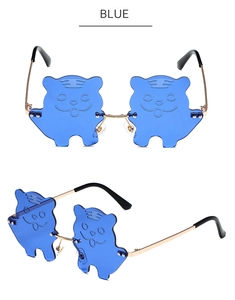 Detail view of cat-shaped rimless sunglasses with blue lenses and gold metal temples