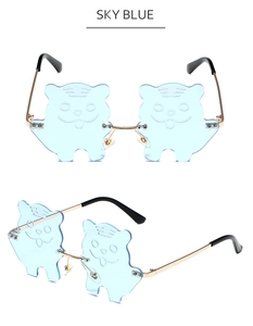 Detail view of sky blue tiger-shaped lenses with gold metal frame sunglasses