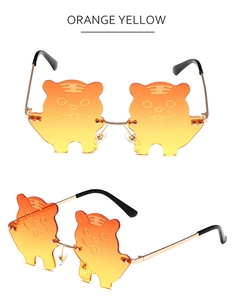 Detailed views of creative tiger face silhouette sunglasses with orange yellow lenses