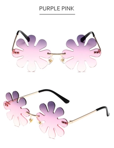 Detail of flower-shaped rimless sunglasses with purple pink gradient lenses and gold frame