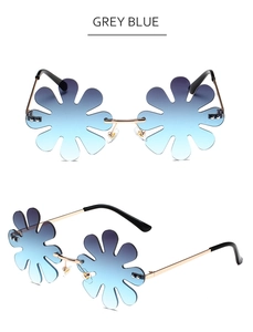 Detail view of flower-shaped rimless sunglasses in grey blue gradient lenses with metal frame