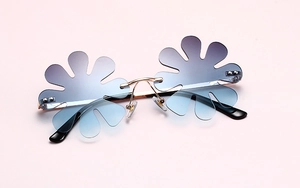 Macro shot of rimless daisy petal lenses with blue purple gradient and gold metal bridge