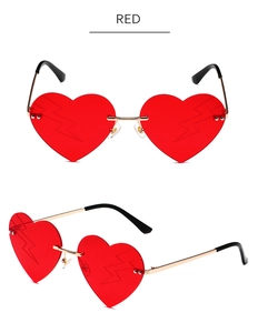 Detail of red heart-shaped rimless sunglasses with unique lightning bolt lens patterns