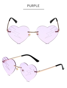 Detail of purple heart-shaped rimless sunglasses with lightning bolt lens engraving