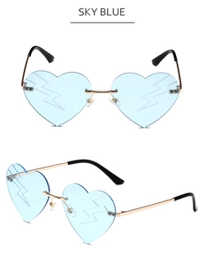 Detail view of sky blue heart-shaped rimless sunglasses with lightning bolt lens engraving