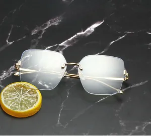 Close-up of rimless blue light glasses with gold metal frames on marble background