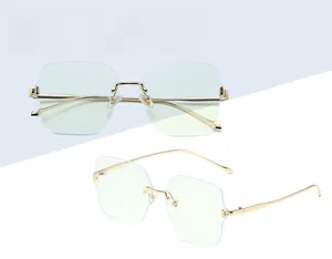 Detail of rimless square blue light glasses with gold metal frames and light blue lenses