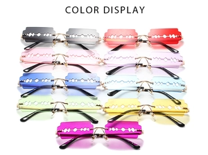 Multi-color razor-shaped rimless sunglasses collection with metallic gold temples and bridges