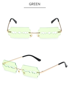 Detail view of green blade-shaped frameless metal sunglasses with gold temples