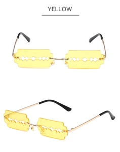 Macro detail of yellow razor blade shaped lenses and golden metal frame on sunglasses
