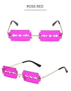 Detailed view of rose red blade-shaped lenses and golden metal frame sunglasses