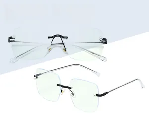 Detail of rimless square glasses with elegant pearl accents on lens and bicolour temples