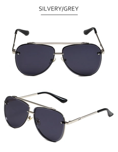 Dettaglio occhiali da sole aviator vintage con doppio ponte in metallo argento e lenti grigie