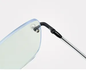 Close-up of a sturdy black metal hinge with a pearl accent on rimless glasses