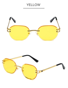 Detail view of yellow rimless sunglasses with gold metal temples and black tips