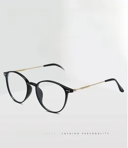Detail view of round blue light blocking glasses with black frames and gold metal temples