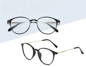 Detail of retro black round glasses frame with lightweight gold metal temples