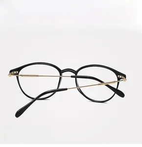 Detail view of round black eyeglass frames with slim gold metal temples and durable hinges