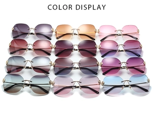 Matrix display of 12 luxury rimless sunglasses with gradient lenses and gold metal temples