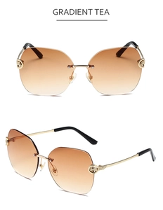 Detail of gradient tea rimless sunglasses with golden leopard emblem on metal temple
