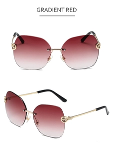 Detail of rimless sunglasses with gradient red lenses and gold leopard head hinge
