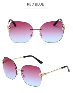 Rimless sunglasses detail with red-blue gradient lenses and panther head gold metal hinge