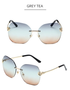 Detailed view of grey tea gradient rimless sunglasses with ornate gold metal temples