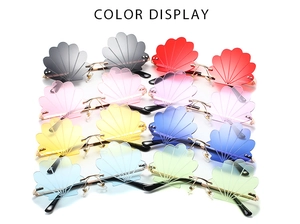 Color display of frameless shell-shaped sunglasses with stylish metal temples and vibrant lenses