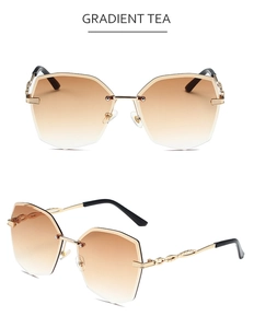 Détail de lunettes de soleil sans monture à verres dégradés thé et branches dorées