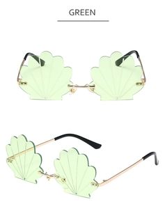 Detailed view of mint green shell-shaped frameless sunglasses with gold metal frame