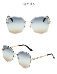 Détail de lunettes de soleil sans monture avec branches chaîne dorées et verres dégradés