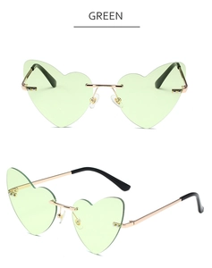 Detail view of heart-shaped rimless sunglasses with green lenses and gold metal temples