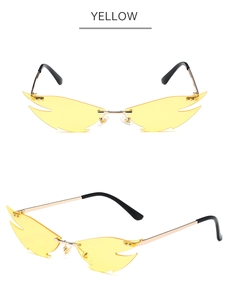 Detail view of yellow flame-shaped rimless sunglasses with golden metal temples