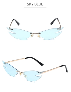Detail view of sky blue flame-shaped rimless sunglasses with gold metal frame