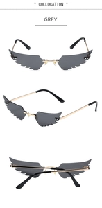 Three-view display of grey wing-shaped sunglasses with golden metal frames and flat lenses