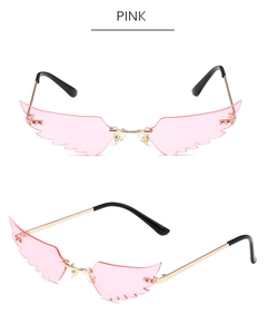 Detail view of pink wing-shaped rimless sunglasses with gold metal temples and sharp cuts