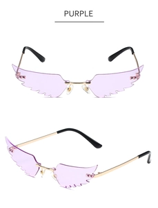 Detail view of purple wing-shaped frameless sunglasses with gold metal temples