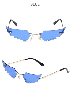 Detail of blue translucent wing-shaped sunglasses with golden metal temples on white background