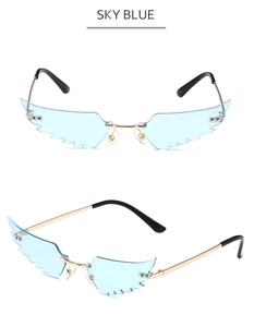 Detail view of sky blue wing-shaped rimless sunglasses with gold metal frame accents