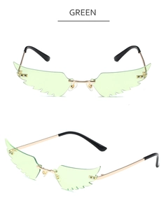 Macro detail of green wing-shaped sunglasses with golden metal frame and resin lenses