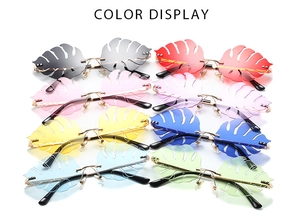 Color display of 8 unique monstera leaf shaped rimless sunglasses in various tints