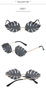 Detailed macro view of tropical leaf-shaped grey lenses with gold metal frame