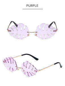 Detailed macro view of purple leaf-shaped rimless sunglasses with golden metal frames