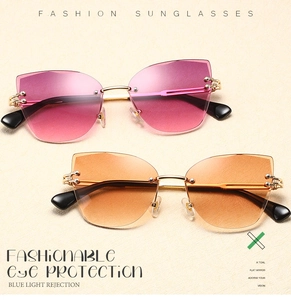Detail view of rimless cat-eye sunglasses with gradient lenses and gold metal nose bridge